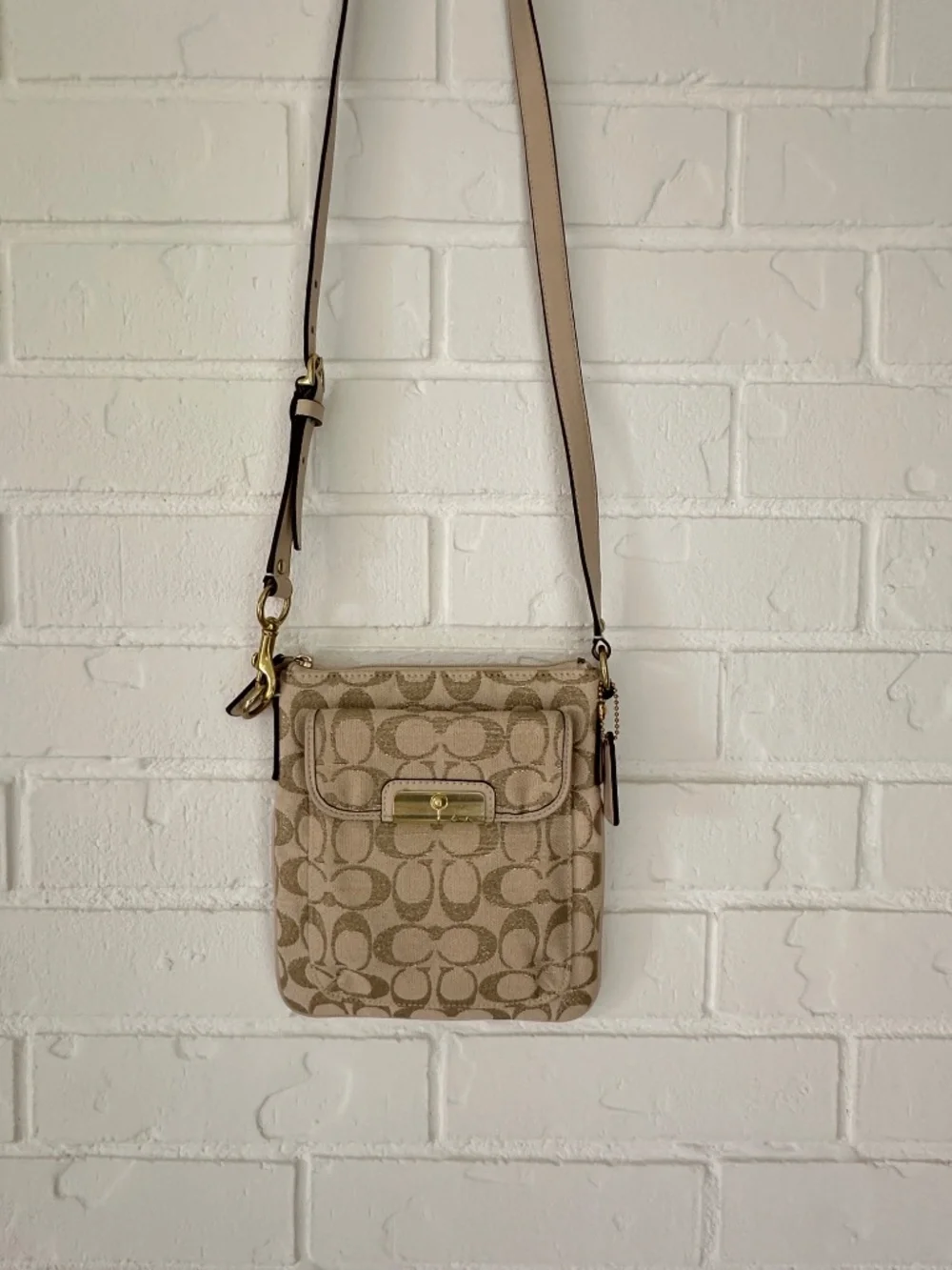 Coach Kristin Signature Crossbody Swing Bag in a metallic gold and beige fabric